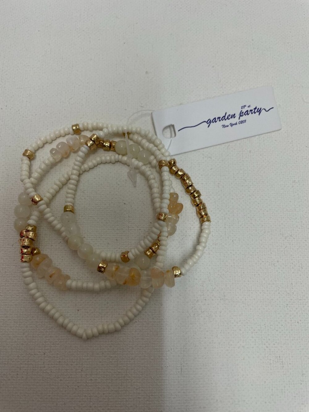 garden party stretch 4 tier bracelet w/white beads and gold nuggets